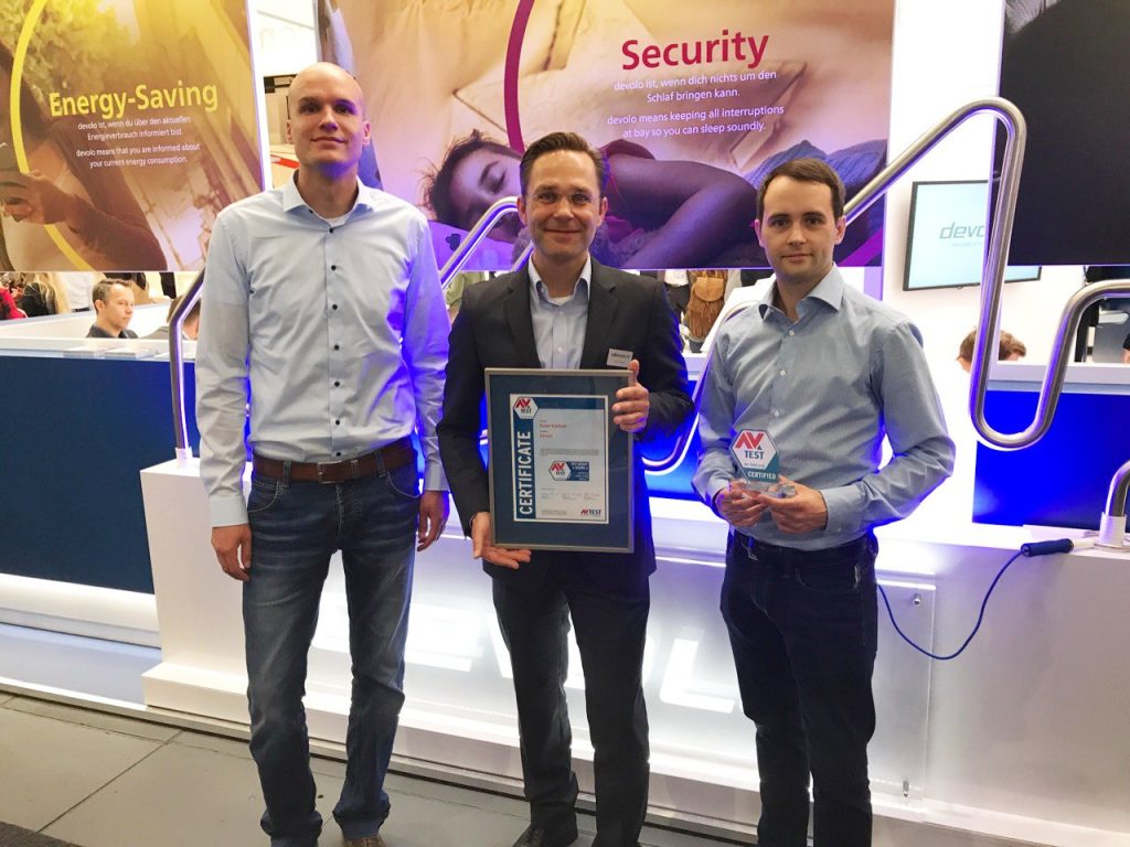 AV-TESTs CTO Maik Morgenstern and IoT Security Expert Eric Clausing awarding Devolo Home Control. Marcel Schüll, PR Manager at Devolo, gets the certificate.